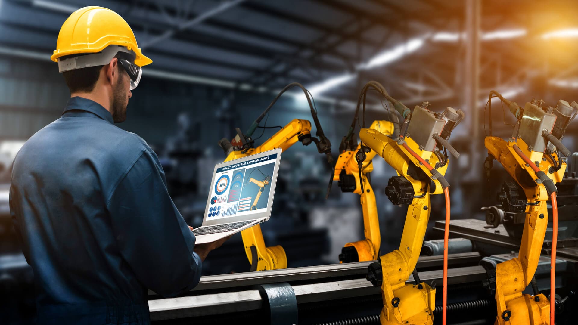 Engineer using laptop in industrial setting